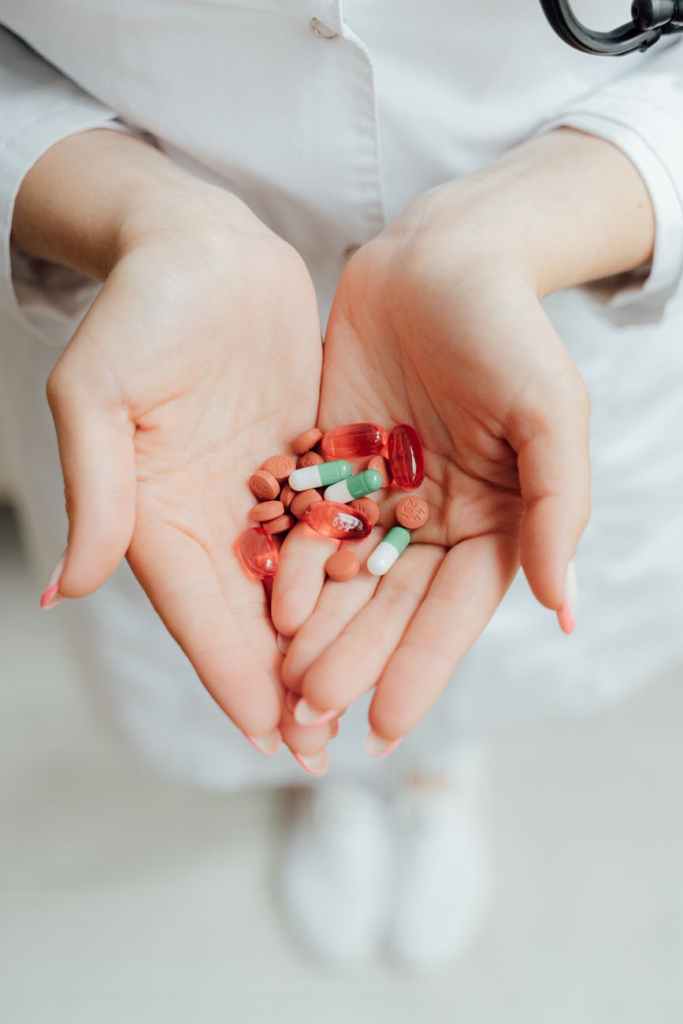 close up of holding different medicines