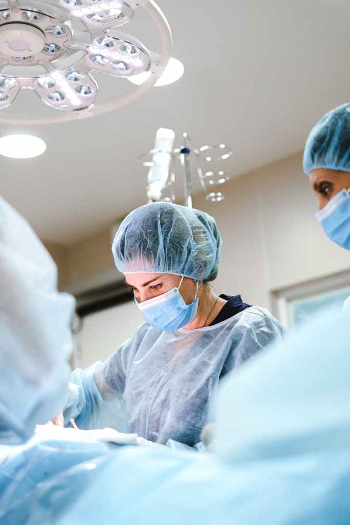 doctor operating a patient