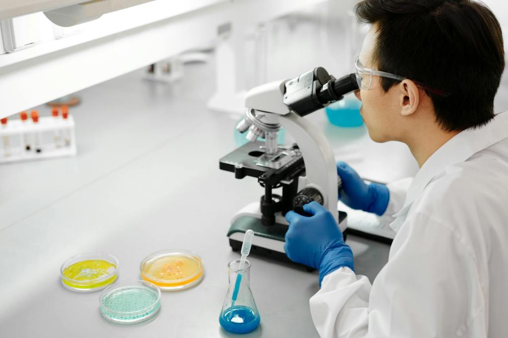 man using a microscope inside the laboratory